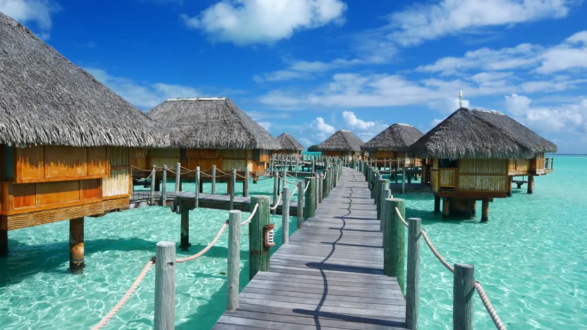 Luxury overwater villas on blue lagoon, white sandy beach and Otemanu mountain at Bora Bora island, Tahiti, French Polynesia
 | Shutterstock HD Video #1016977075
