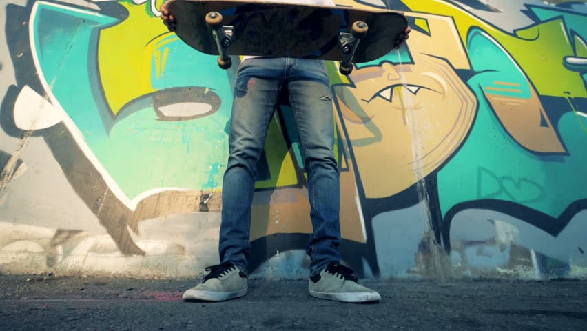 Teenager dropping a skateboard with pink color, slow motion.