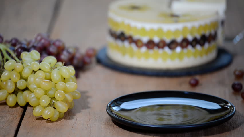 Piece homemade mousse cake with grapes.