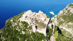 Aerial drone video of iconic medieval fortified castle of Aggelokastro with amazing views, which is also referred to as Angel Castle located in close to Paleokastritsa, Corfu island, Ionian, Greece