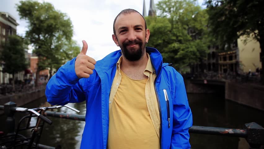 Portrait of an Adult Man giving thumbs up, Outdoor