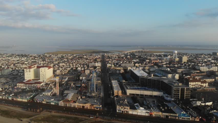 Aerial Drone Airplane Views Of Island And City Below, Ocean City New Jersey Town and Beach Hotels, Clear Skies On Horizon 