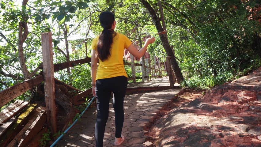 Women walking on wooden bridge in mountain