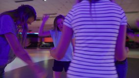 Slow motion shot of girls dancing and singing in circle at roller skating rink / Orem, Utah, United States - Powered by Shutterstock - Get 15% off with code: PIKWIZARD15