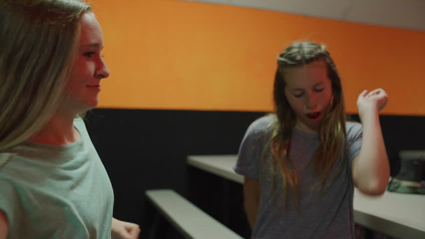 Close up of girls sitting at table singing and dancing to music / Orem, Utah, United States