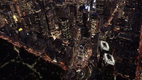 New York City Circa-2015, aerial shot at night tilting down from a view of Midtown and Downtown Manhattan, revealing Columbus Circle and Central Park from above