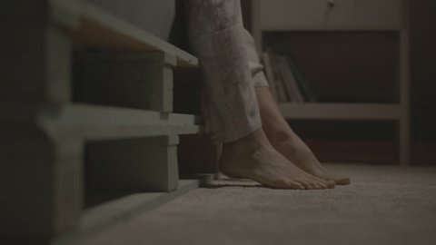 Close up feet of a woman waking up from bed in the middle of the night and walking towards the camera, 3840x2160 shot with alexa mini