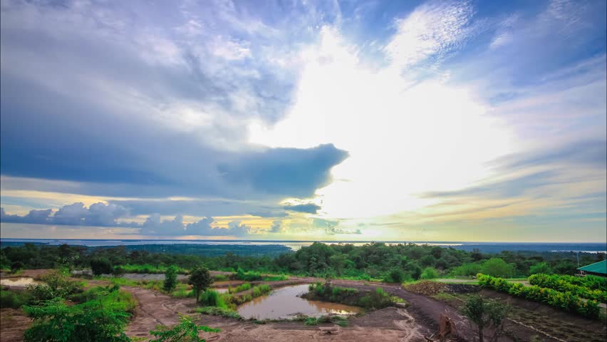 Clouds are moving across the river at sunset