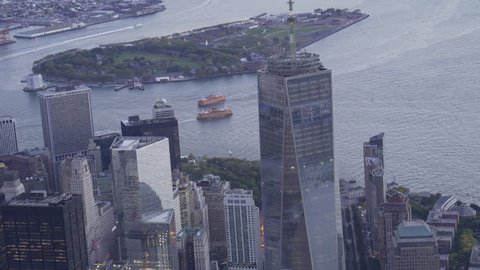 New York City Circa-2015, telephoto aerial view of Lower Manhattan Financial District office buildings and the Staten Island Ferry at dusk