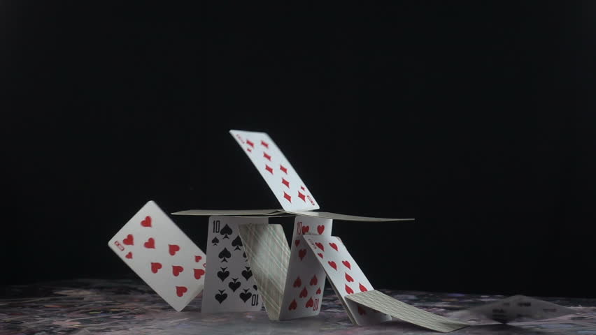 This stock video shows a stack of playing cards built into a castle. The cards topple down on its own weight. This clip is perfect for projects about the fall of a business or empire. 