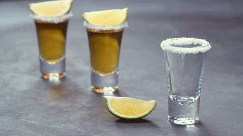 Pouring gold tequila on a black background ,selective focus