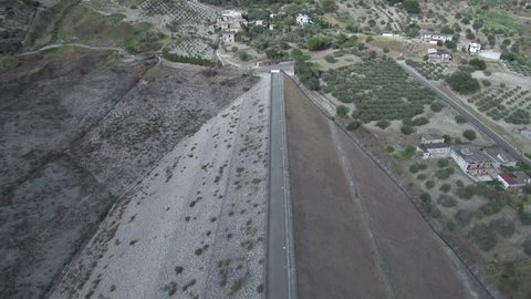 Aerial shot along a dam or dyke