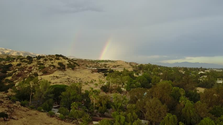 Rainbow over the hills aerial view