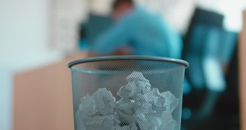 Disappointed employee tossing away crumpled paper into trash can. 4K UHD 60 FPS SLOW MOTION Stockvideo