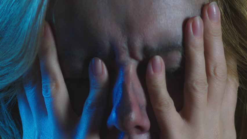 4k, slow motion, Halloween. tired woman in the costume of a terrible witch, erases the make-up from her face with her hands. close-up