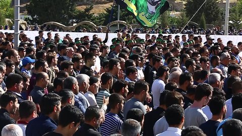 Baku, Azerbaijan - 20 SEP 2018: Crowds of Azeri men have gathered to take part in a sombre parade to commemorate the martyrdom of Hussain, as part of Ashura and Muharram, in Baku