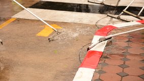 People are cleaning up the floor after a torrential rain.Cleaning road floor - Powered by Shutterstock - Get 15% off with code: PIKWIZARD15