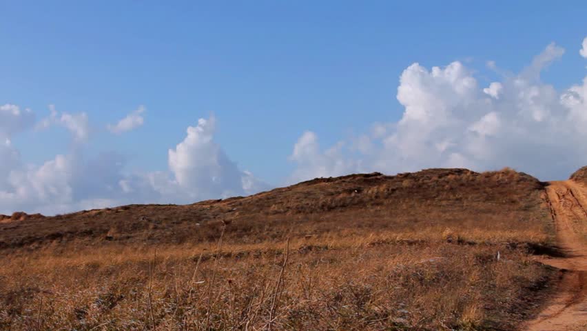 Off road sand dune motocross and auto sport track on blue sky background