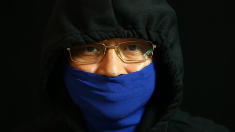 Thai man in hood and  mask with black  background