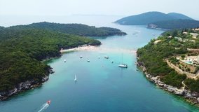 Aerial drone bird's eye view video of iconic paradise sandy beaches with turquoise sea in complex islands of Agios Nikolaos and Mourtos in Sivota area, Epirus, Ionian, Greece