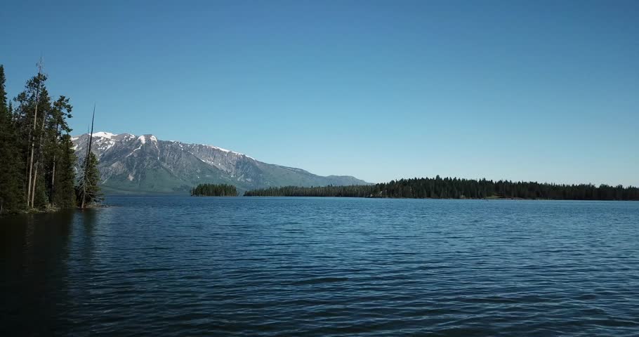 Aerial footage of Grand Teton Mountain Range and Jackson Lake - Teton, Wyoming