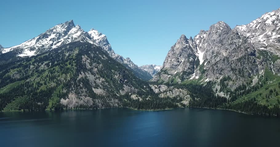 Aerial footage of Grand Teton Mountain Range and Jackson Lake - Teton, Wyoming