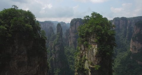 Amazing mountain aerial view. Flying through the spectacular mountain landscape of Zhangjiajie, a national park in China known for its surreal scenery of rock formations.