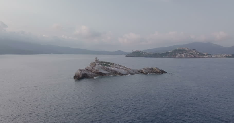 Aerial view of Scoglietto Lighthouse, a lighthouse on the summit of a rocky islet without vegetation in front of Portoferraio, Elba island (Italy)