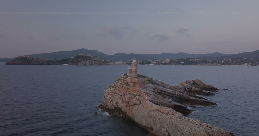 Aerial view of Scoglietto Lighthouse, a lighthouse on the summit of a rocky islet without vegetation in front of Portoferraio, Elba island (Italy)