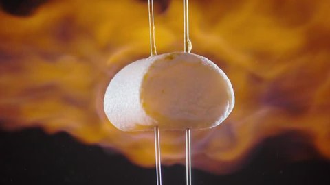 Roasting marshmallow slow motion video.