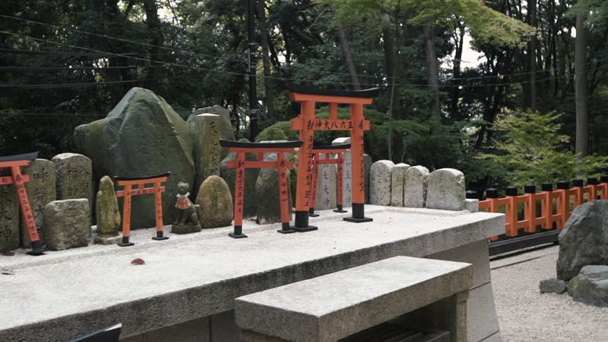 Wide shot of Torri gate and cemetery with Japanese script, Kyoto City, Kyoto Prefecture, Japan