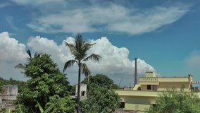 A time lapse video showing movement and transformation of cumulus clouds behind tree in North Chennai, Tamil Nadu in India