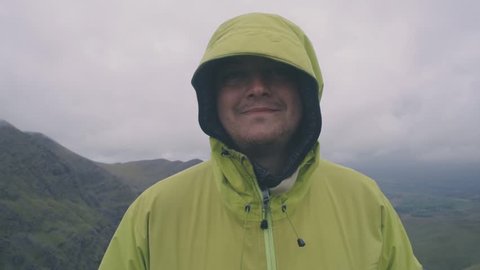 Portrait of man hiker in mountains. Male hiking on Carrauntoohil mount in Ireland