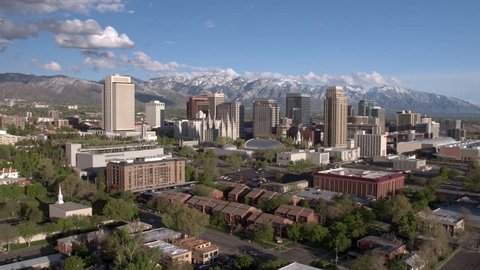 Salt Lake City, Utah skyline against the snow capped Wasatch Front mountains.