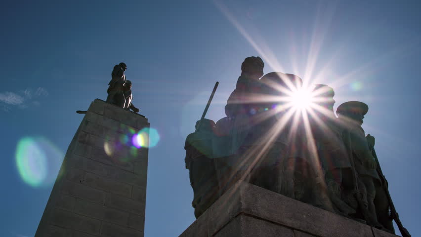 Time lapse of sun flares moving through This is the Place mounment on sunny day.