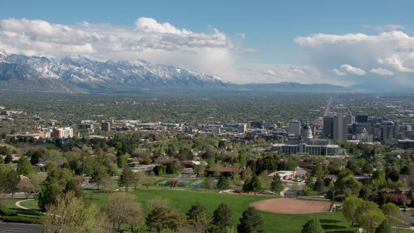 Time lapse over Salt Lake City panning across the valley viewing the city and snow covered Wasatch Mountains.