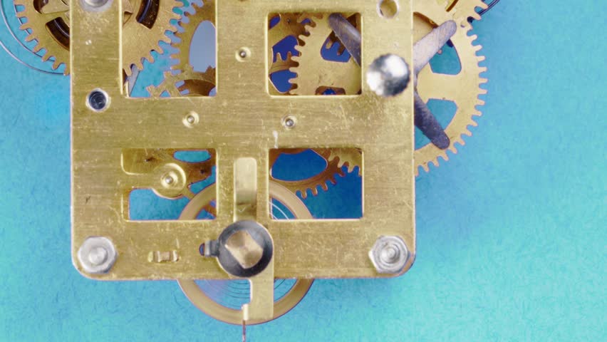 close up detail of running clock or watch machinnery on a bluebackground. Copy space available and suitable for time concepts as time goes by, Daylight saving time or growing old.