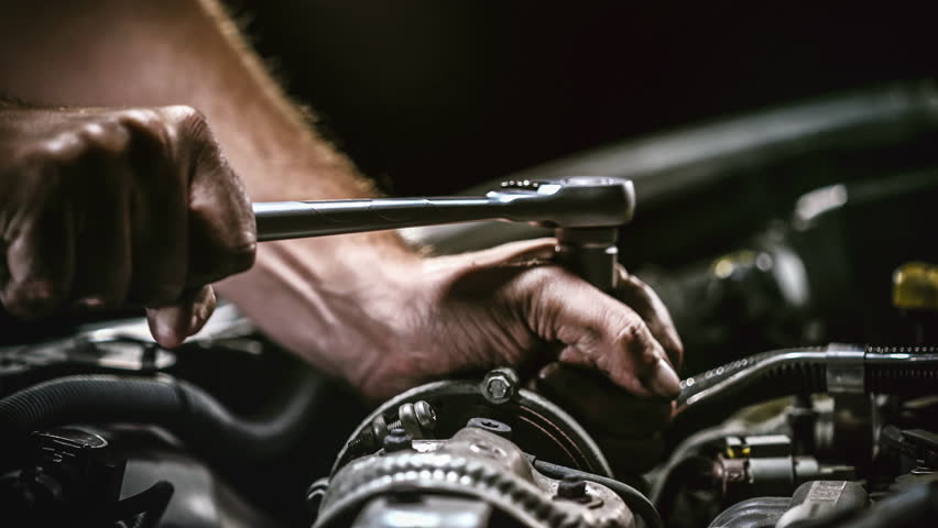 Auto mechanic working on car engine in mechanics garage. Repair service. authentic close-up shot (Shot on RED) | Shutterstock HD Video #1017064897