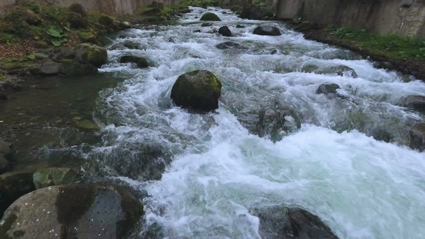 Fast rocky river flowing in Caucasian mountains in Kutaisi, travel to Georgia