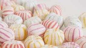 Tilting on striped round candies close-up 4K footage