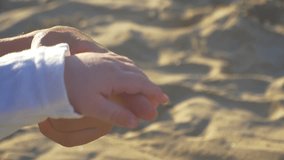 A video showing the palmar grasp reflex, grasp reflex, or primitive reflex. The hand of a baby boy grabs the index finger of his mother. It was shot on the Raco beach, in Cullera, Spain, Europe.