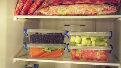 Freezing meals. Fridge Organization. Packages and containers with frozen fruits and vegetables. Food storage