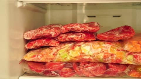 Household refrigerator with frozen vegetables. To Blanch And Preserve (Freeze) Fresh Vegetables (carrots, pepper, tomato, zucchini) and Berries