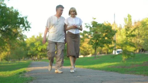 romantic mature couple walking in the park,4k  3