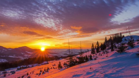 Sunrise over the Winter Mountain Forest on the Background of Dramatic Cloudy Sky. Timelapse. 4K.

