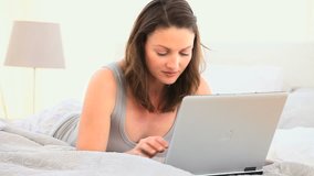 Joyful woman working on her laptop