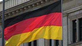 4K. Flag of Germany waving in the wind in front of a historical building in Berlin. German flag is blowing-Adrian - Powered by Shutterstock - Get 15% off with code: PIKWIZARD15