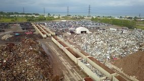 Aerial drone footage of a junk yard with row after row of wrecked cars. - Powered by Shutterstock - Get 15% off with code: PIKWIZARD15