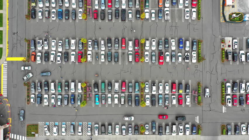 4k time lapse footage of a shopping mall parking lot, high angle view looking directly down Royalty-Free Stock Footage #1017112072