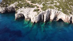 Aerial drone bird's eye view video of tropical caribbean paradise blue bay with white rock caves and turquoise clear sea